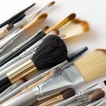 set of cosmetic professional makeup brushes on white